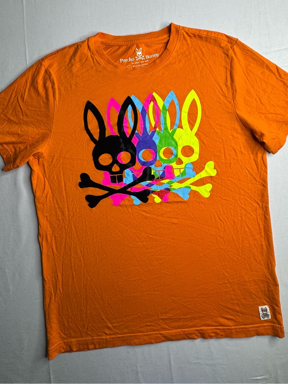 Psycho Bunny Orange Tee with Neon Multi-Skull Graphic